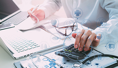 medical professional crunching numbers on their Medical Insurance in Greeley