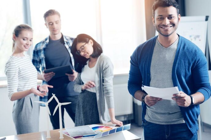 Group of Employee's Talking and Smiling After Receiving Employee Benefits Packages in Longmont, Loveland, Windsor, Greeley, and Fort Collins