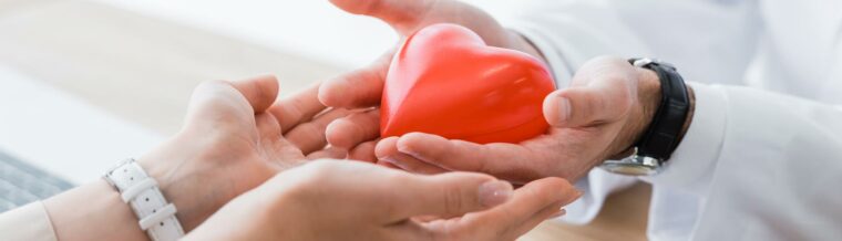 Patient and Nurse Holding Toy Heart in Hands for Medical Insurance in Greeley, Longmont, Loveland, Windsor, and Fort Collins