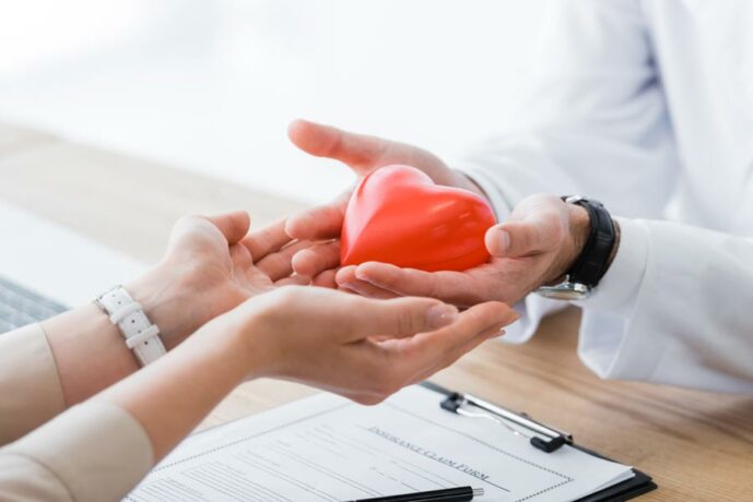 Hands Holding Fake Heart for Health Insurance in Longmont, Greeley, Fort Collins, Loveland, Windsor